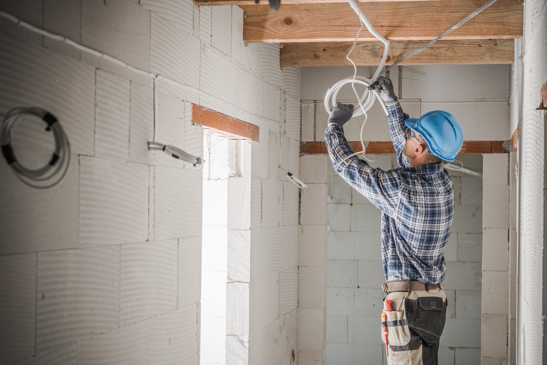 Worker Installing Electrical Cables Line